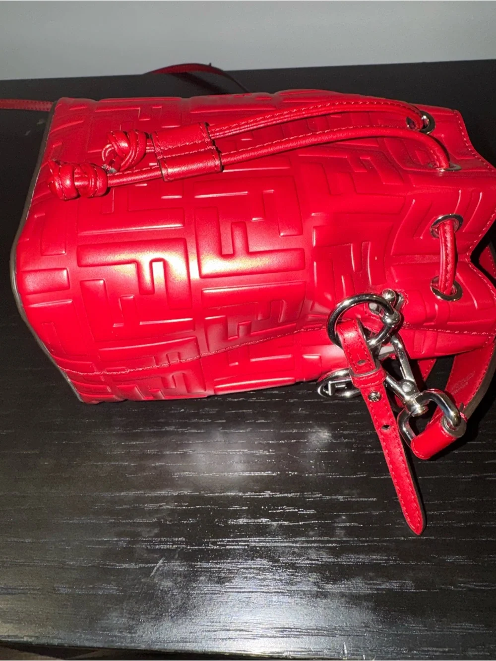 Fendi Mon Tresor mini bucket bag in a vibrant red hue with embossed FF logos